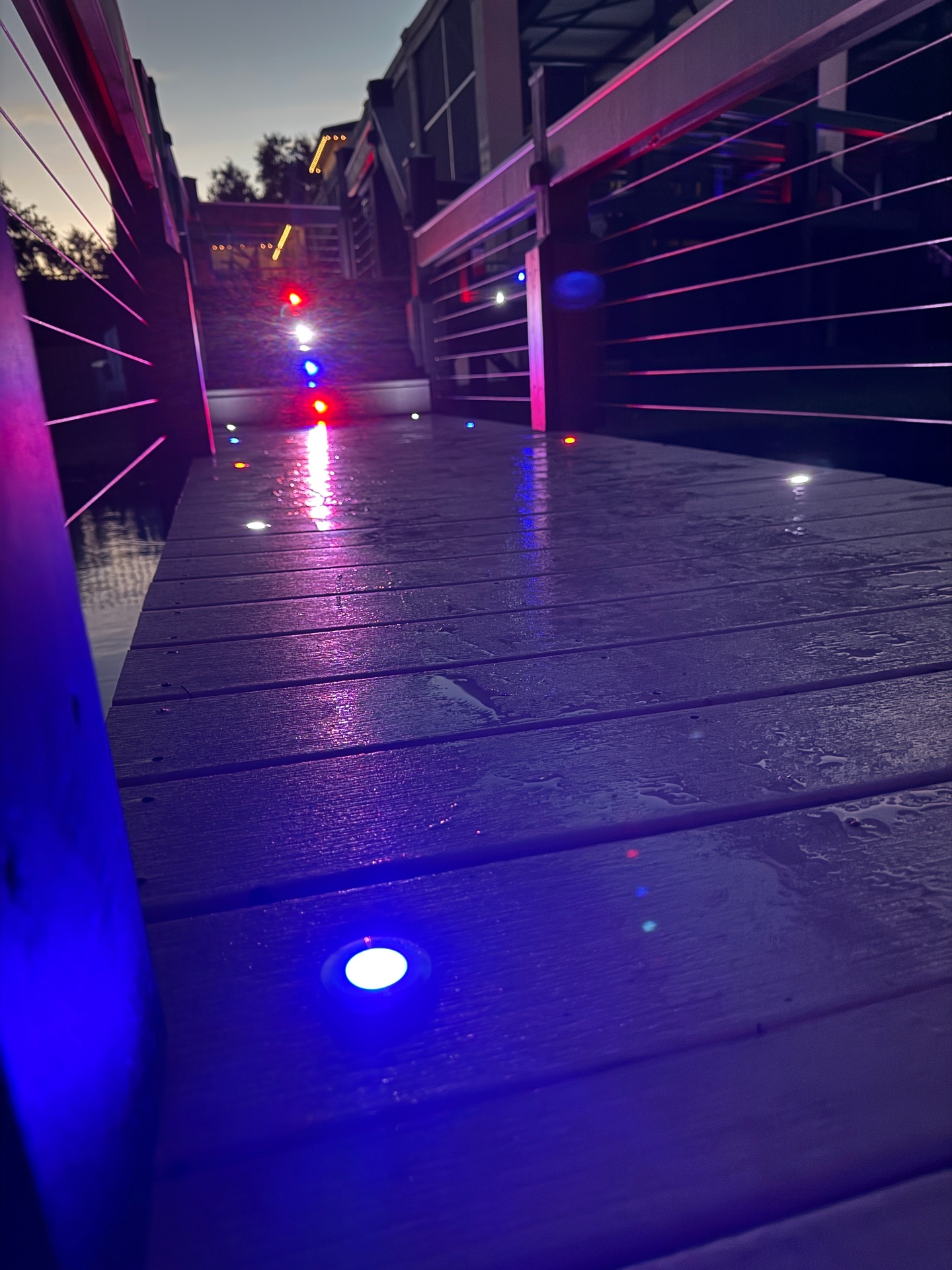 Wet dock walkway lit with recessed color-changing deck lights in blue, red, and white