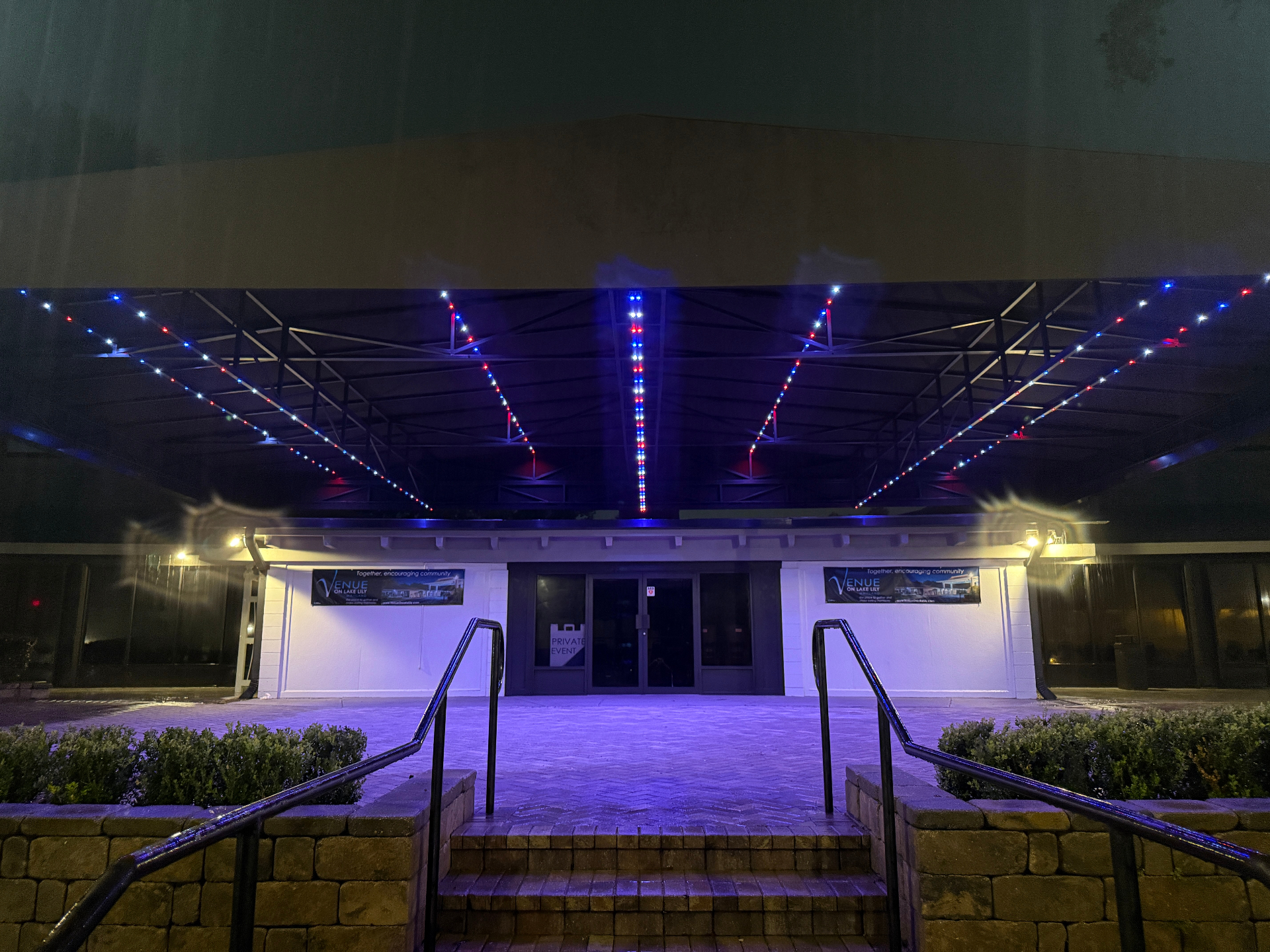 Commercial pavilion structure outlined with permanent red, white, and blue LED lighting