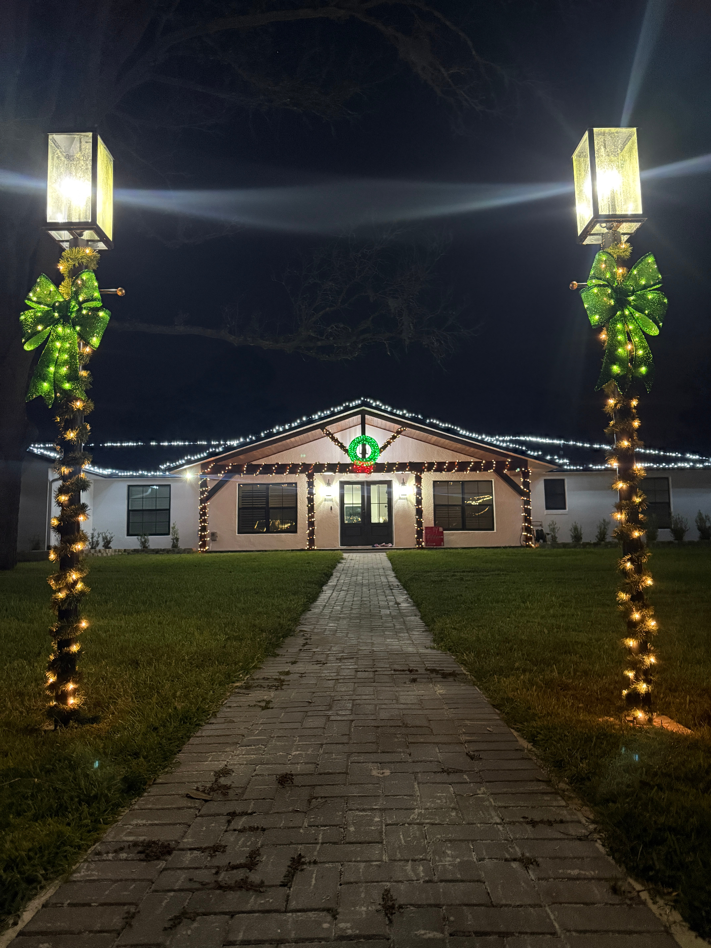 Home entry framed by holiday lighting, garland, and wreath accents