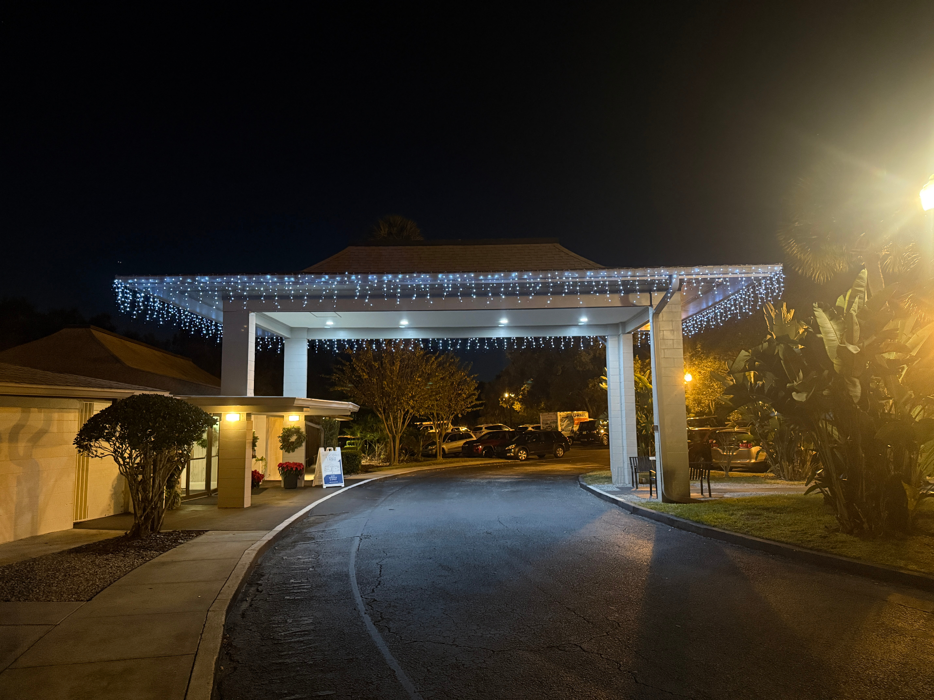 Commercial porte cochere outlined with white icicle holiday lights